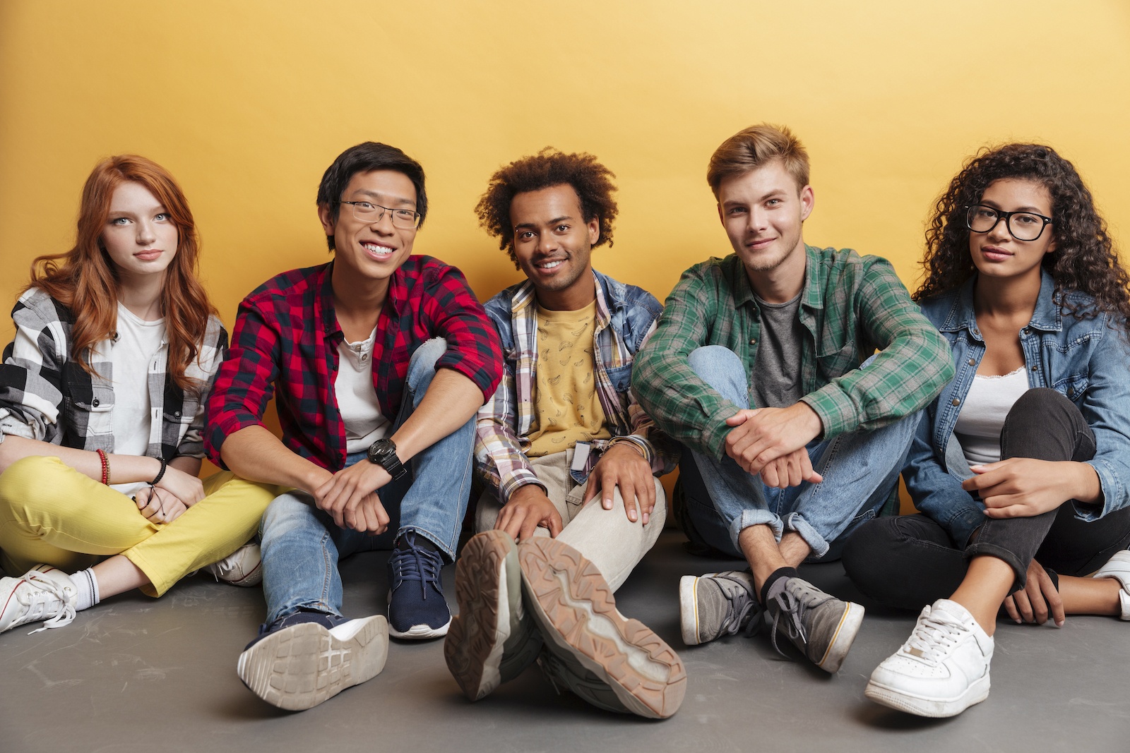 Group of people sitting together over yellow background